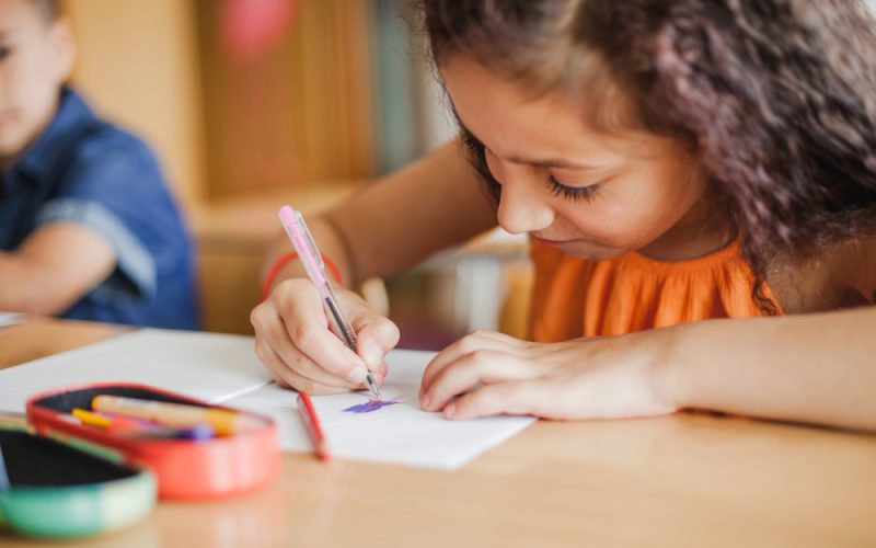 schoolgirl-sitting-table-drawing